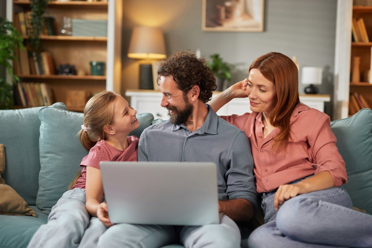 Family enjoying high-speed internet on multiple devices in modern living room